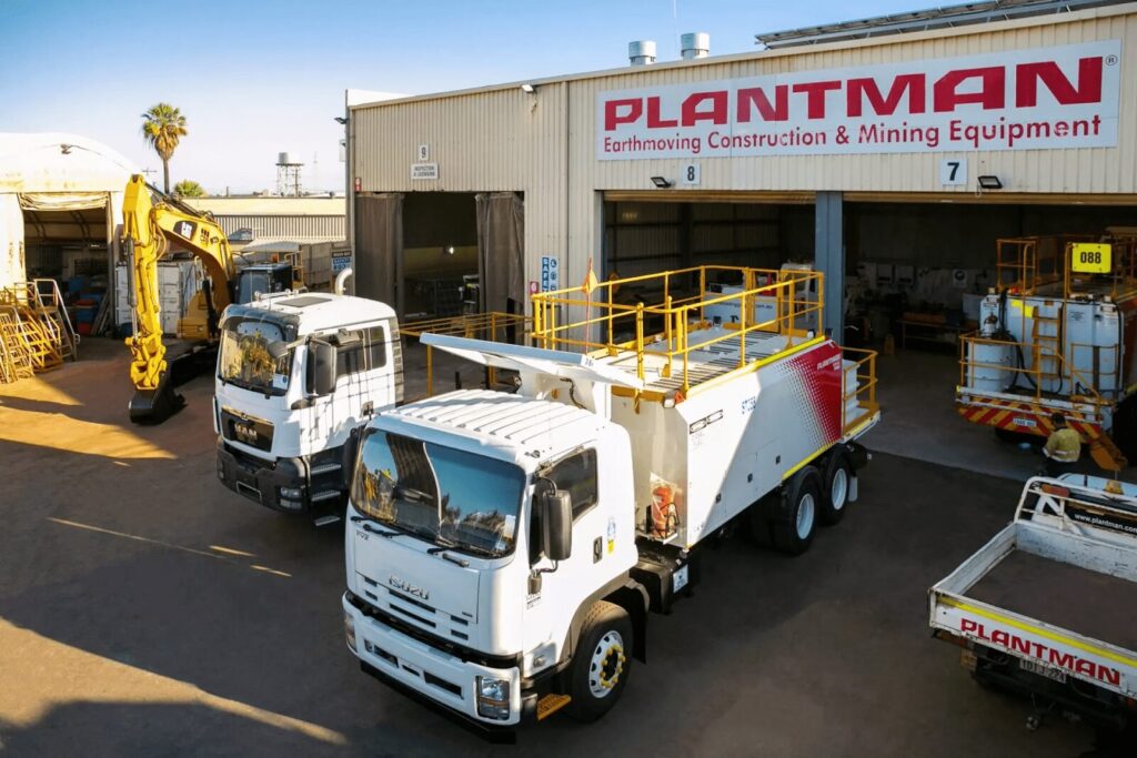 Service trucks parked in the Plantman warehouse.